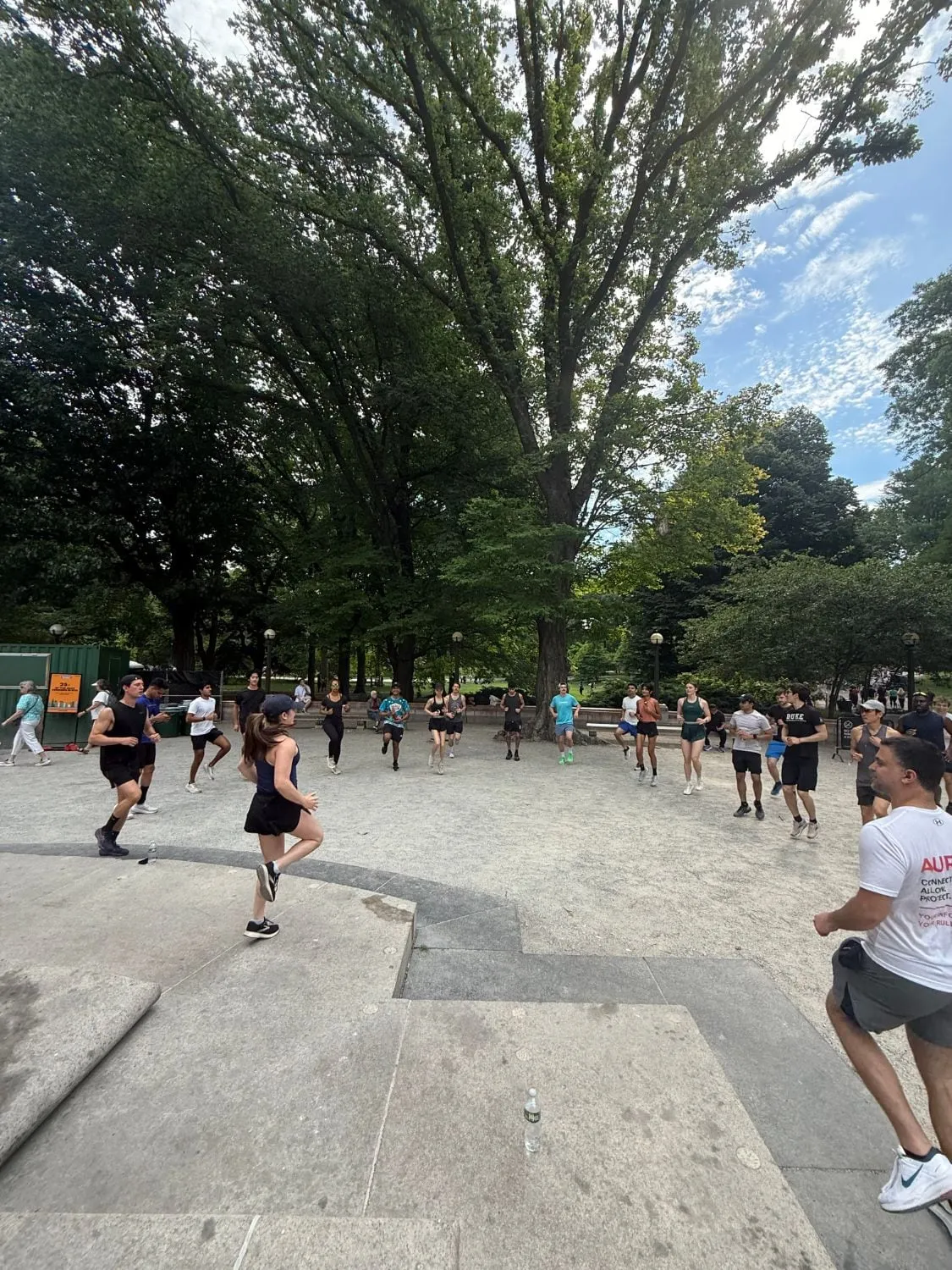 a big group warming up together before a run in central park